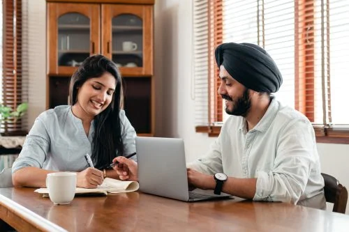 Beneficiary represented by a couple writing notes and doing research.